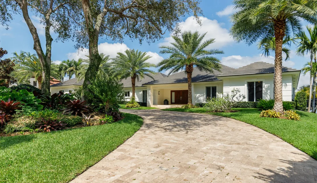 Houston house with a palm-lined driveway